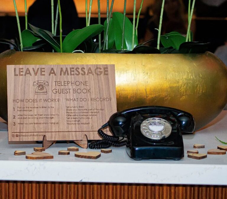 Vintage telephone guest book with wooden instruction sign.